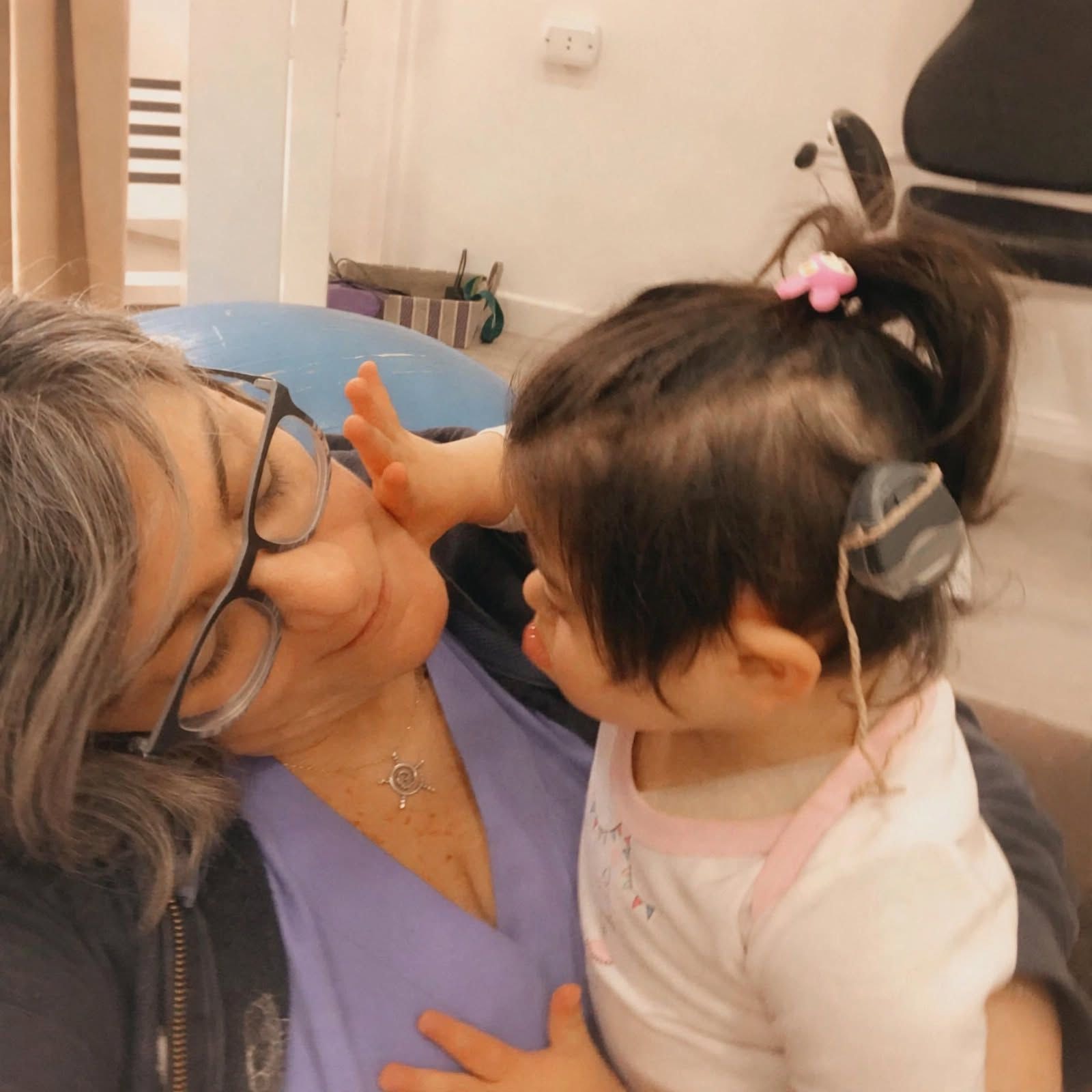 Doress Naffaa smiling with a young child in her arms