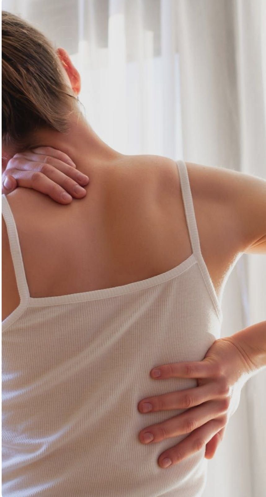 Woman resting one hand on her neck and the other on her lower back